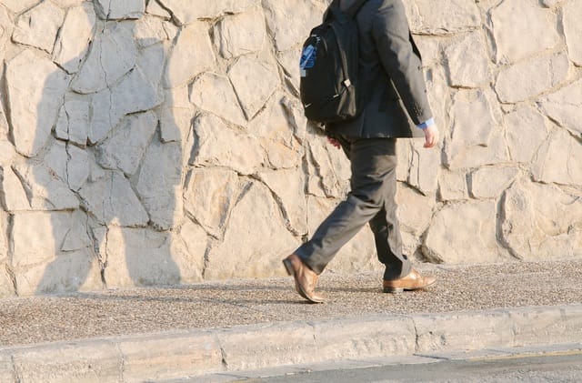 Commuter walking on pavement